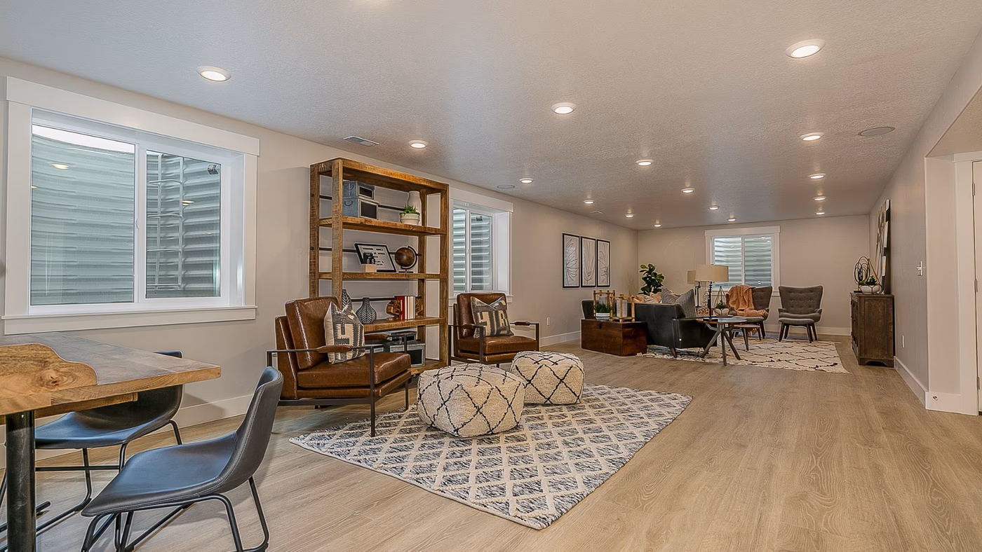 Open concept basement living space with luxury vinyl plank flooring